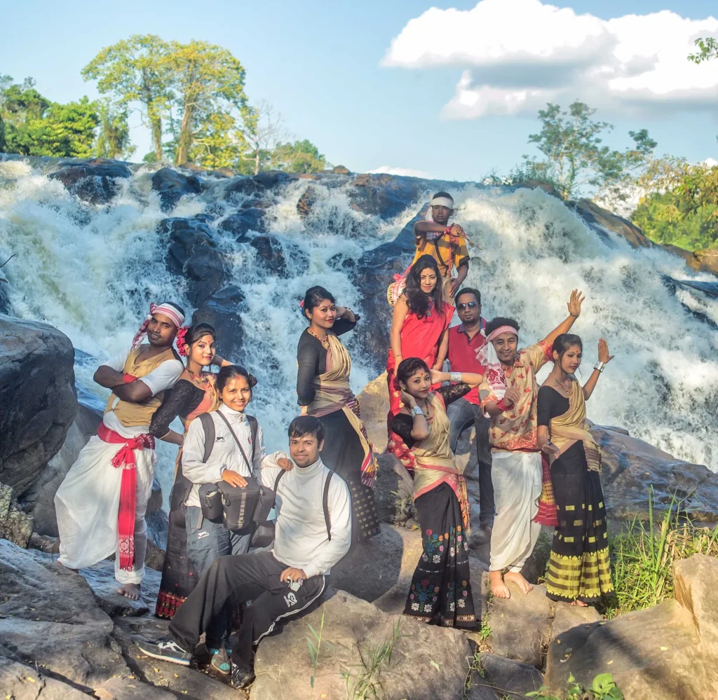 Cast and crew at a waterfall location for the Maghor Bihu music video