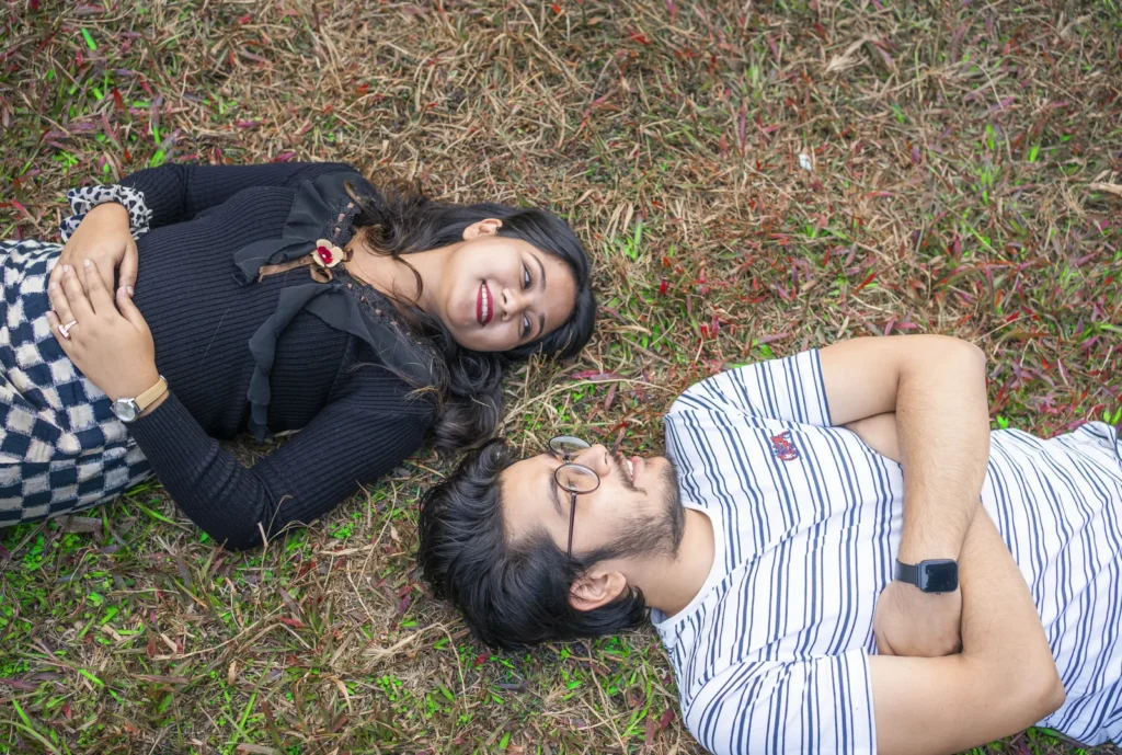 Couple lying on grass in a music video by TD Film Studio